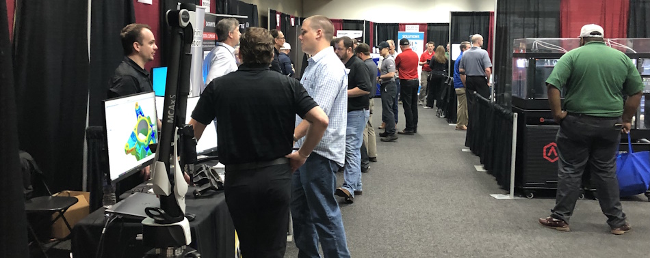 People learning about the various technologies exhibitors brought