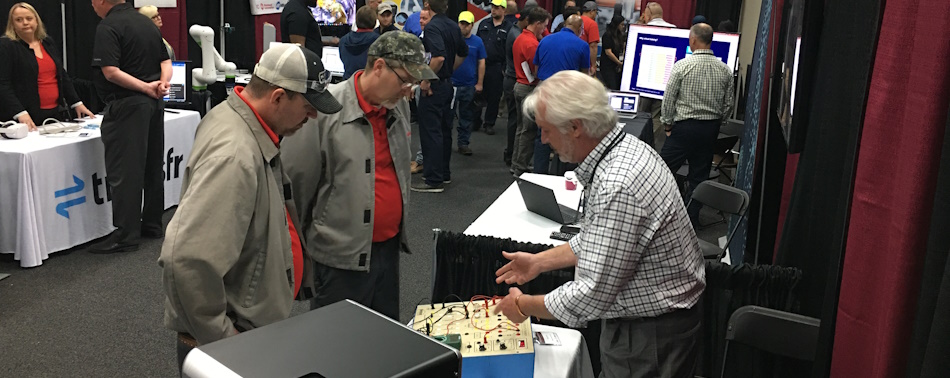 People learning about the various technologies exhibitors brought