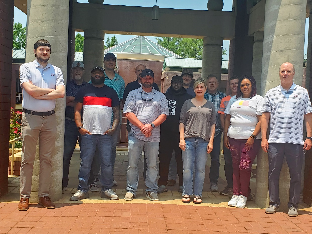 Pictured:  Six Sigma Instructors Adam Collins (far left) and Les Goff (far right) with employees of             Yokohama Tire who participated in CAVS-E