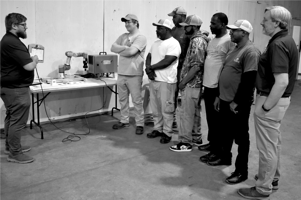 
CAVS-E engineers demonstrate collaborative robots for a group of students - photo by Andy Lewis, Woodville Republican